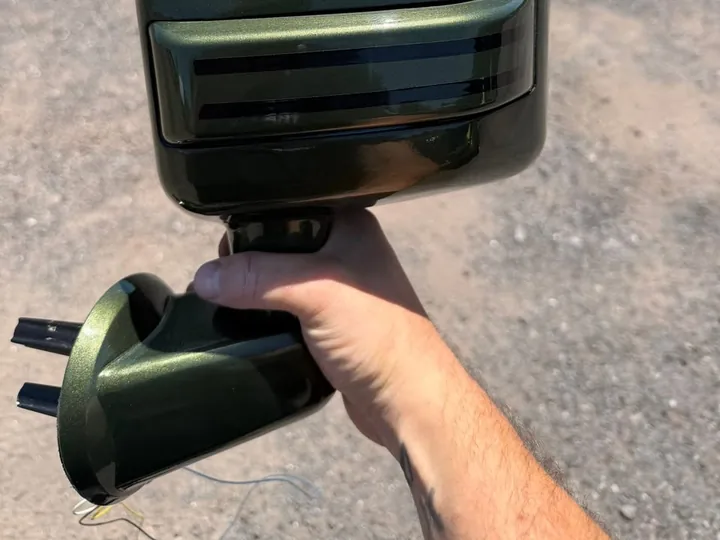 Freshly painted dark green Jeep mirror with a slim turn-signal line
