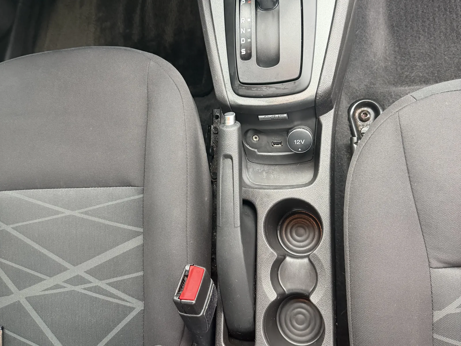 Ford center console after interior detailing, with cleaned controls and cup holders.