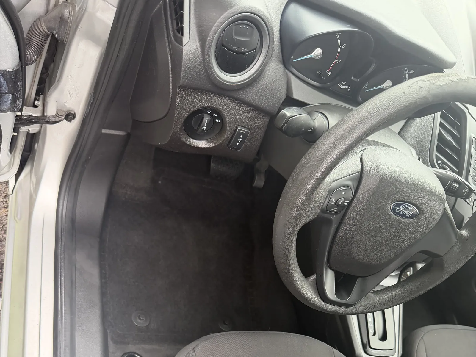 Ford driver area after interior detailing, with a cleaned floor and seat.